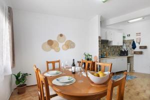 a dining room table with a bowl of fruit on it at Casa Amarela in Tavira