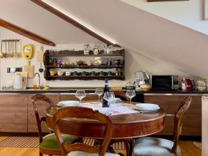a kitchen with a table with wine glasses on it at La Casa Del Sole in Terzolas