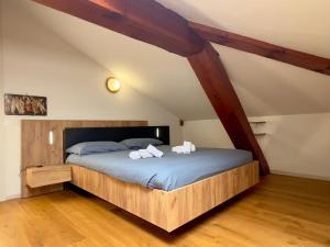 a bedroom with a bed with two towels on it at La Casa Del Sole in Terzolas