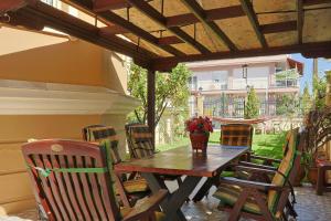 a wooden table and chairs on a patio at Zeusplace Villa Evelin in Andromáchi