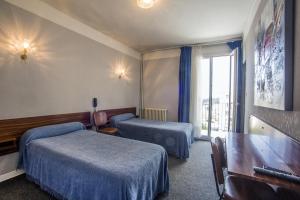 Postel nebo postele na pokoji v ubytování Hôtel Sampiero Corso