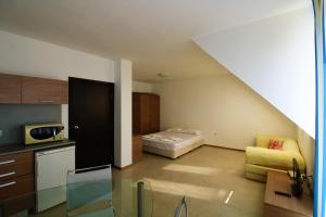 a kitchen and a living room with a couch at Belle View - Menada Apartments in Sveti Vlas