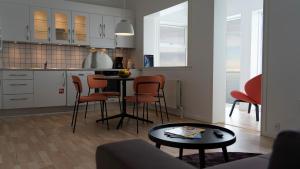 a kitchen with a table and chairs in a room at Hotel Arctic in Ilulissat