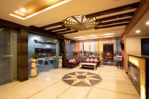 a large living room with couches and a fireplace at Hotel O DG College Chelambra in Ferokh +3 photos