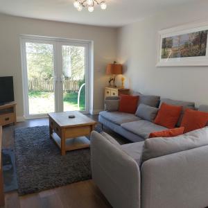 a living room with a couch and a table at Sunnydale, Cartmel in Cartmel