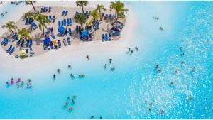 a group of people swimming in the water at a beach at Villa Almendro Santa Rosalia Lake and Life Resort by PREMIUM SPAIN PROPERTIES in Torre-Pacheco
