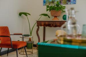 a room with a table and two chairs and a plant at Palazzo Villelmi in Cefalù