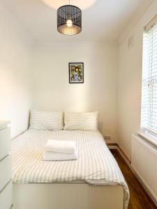 a bedroom with a bed with two towels on it at Folkestone Oasis - Central 2 Bedroom Apartment - Pets Welcome! in Folkestone