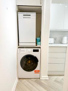 a washer and dryer in a small kitchen at Folkestone Oasis - Central 2 Bedroom Apartment - Pets Welcome! in Folkestone +14 photos