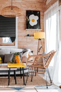 a living room with a couch and a table and chairs at Mereäärne helesinine suvemaja in Tahkuranna +16 photos