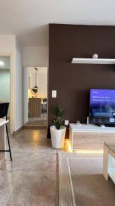 a living room with a tv on a brown wall at Apartamento en Canet De Berenguer Playa - Valencia in Valencia +29 photos