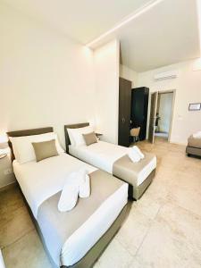 Postel nebo postele na pokoji v ubytování Hotel Paradise Rooms