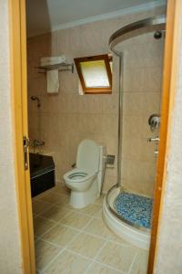 a bathroom with a toilet and a sink and a shower at Loft in Kiyovu, Kigali in Kigali