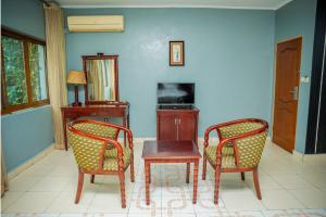 a room with two chairs and a table and a desk at Loft in Kiyovu, Kigali in Kigali +3 photos