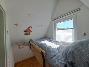 a small bedroom with a bed and a window at Ferienhaus Siebenschläfer mit privater Sauna in Bad Wünnenberg