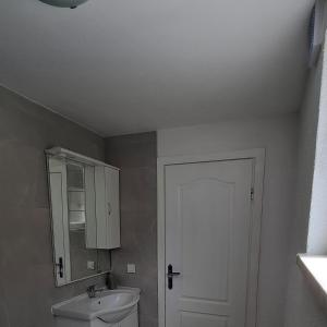 a bathroom with a white toilet and a cabinet at Grofova Kuća in Lipovlje +24 photos