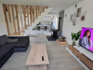 a living room with a couch and a coffee table at Grofova Kuća in Lipovlje