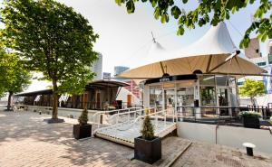 
an outdoor patio with umbrellas on a sunny day at H2OTEL Rotterdam in Rotterdam
