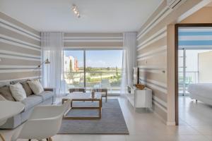 a living room with a couch and a table at Laguna - Vilamoura in Vilamoura
