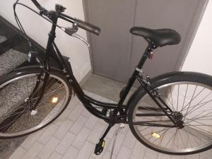 a black bike parked next to a door at Bed & Breakfast La Mansarda in Naples
