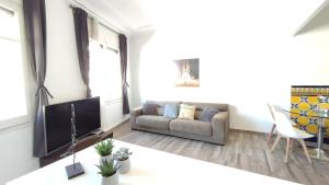 a living room with a couch and a tv at Enjoy this apartment, with two bedrooms in Sant Adria de Besos +4 photos
