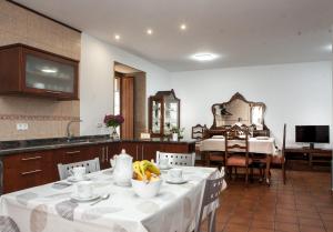 a kitchen and dining room with a table with bananas on it at Casa De Rama in San Mamede de Carnota