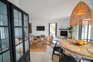 a room with a table and chairs and a living room at Casa El Cholo, Mijas Hideaway in Mijas