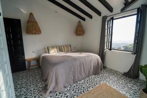 a bedroom with a bed and a large window at Casa El Cholo, Mijas Hideaway in Mijas +54 photos