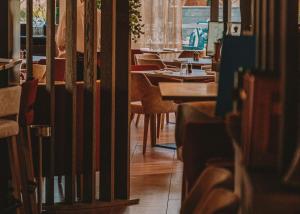 a row of tables and chairs in a restaurant at Rivage Hôtel & Spa Annecy in Annecy