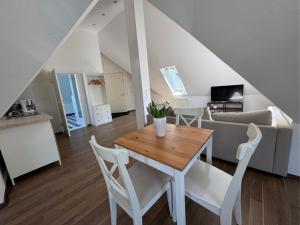 a dining room and living room with a table and chairs at Villa Am Park in Bad Homburg vor der Höhe
