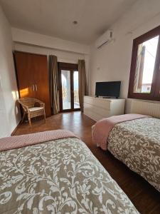 a hotel room with two beds and a television at KlaireyBelles in Dáfia