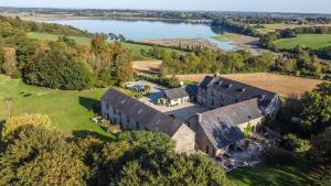 an aerial view of a mansion with a lake at Manoir De Rigourdaine in Plouër-sur-Rance