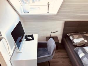 a bedroom with a bed and a desk and a chair at Casa Romano in Lüneburg