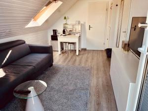 a living room with a couch and a table at Casa Romano in Lüneburg