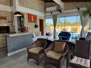 a living room with a table and chairs and a fireplace at Pousada Mirante dos Canyons in Praia Grande