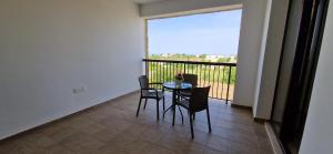 a table and chairs on a balcony with a view at Daniel's Hotel Apartments in Paphos