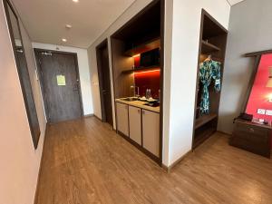a room with a hallway with a kitchen with a counter at Apec Mandala Muine in Mui Ne