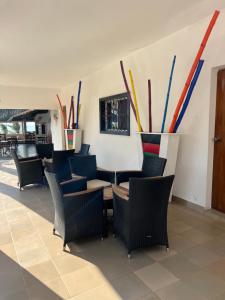 a group of chairs and tables in a restaurant at VilladesPêcheurs Beach in Cap Skirring