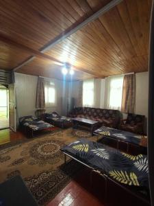 a large living room with couches and a wooden ceiling at Hostel 555 by VL in Alaverdi +20 photos