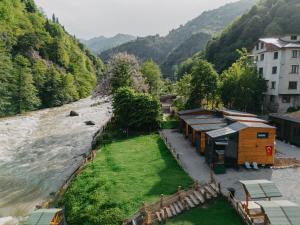 an aerial view of a river with houses and trees at Lavender Tiny House in Çamlıhemşin