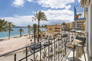 a balcony with a view of the beach and buildings at Velamar in Aduanas