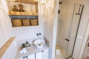 a bathroom with a shower and a sink at Velamar in Aduanas +11 photos