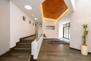 a hallway of a house with stairs and a wooden ceiling at 5BR Poblado Villa close to Lleras Jacuzzi Cinema AC in Medellín