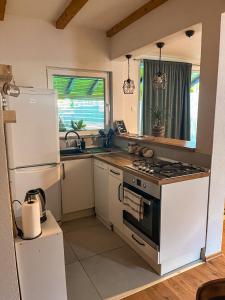 a kitchen with a white refrigerator and a stove top oven at Rivergreen in Banja Luka