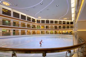 a person on a dance floor in a large building at Hyatt Regency Dubai - Corniche in Dubai