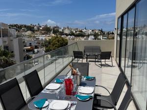 un tavolo su un balcone con vista sulla città di Bright and Modern 2 Bedroom Penthouse a Is-Swieqi