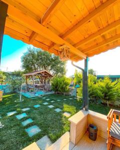 a patio with a gazebo and a playground at Nur Konak Bungalov 7 in Çanakkale