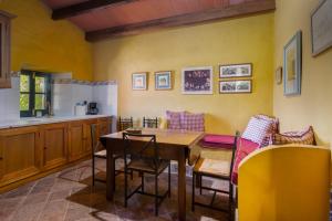 a kitchen with a table and chairs in a room at Molino Chirrin in Constantina