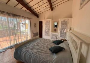 a large bed in a room with a large window at Wood Lodge - Sleeps10 - Skiing - Thermal Baths in Los Masos