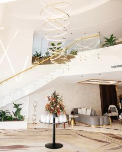 a lobby with a staircase and a table with flowers at Villa Misk Alkhobar in Al Khobar
